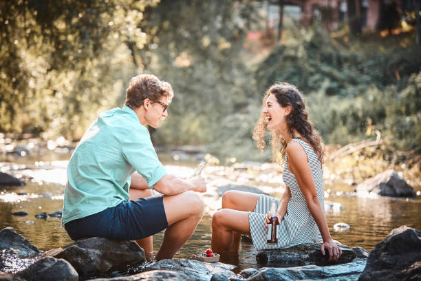 istock Couple have a picnic in stream at sunset 1147567832