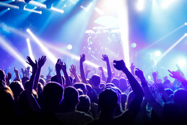 istock Raised hands in honor of a musical show on stage 1147568762
