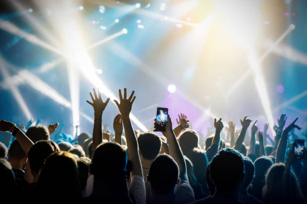 istock Raised hands in honor of a musical show on stage 1147568792