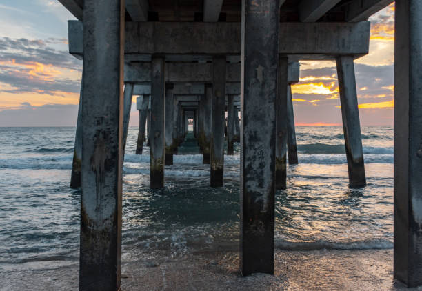 istock colorful sunrise from under the pier 1147569895