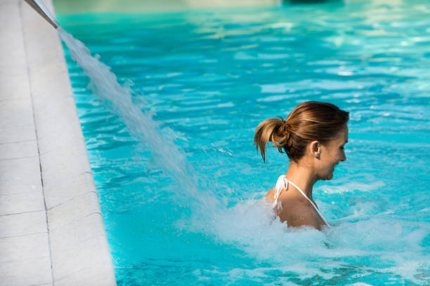 istock relaxed woman in a pool 1147570945