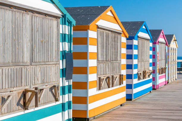 Colorful, striped beach Cabanas Beach cabanas in bright, bold colors taken in Hastings, UK beach hut stock pictures, royalty-free photos & images
