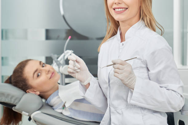 istock Dentist and patient posing, smiling in clinic. 1147577594