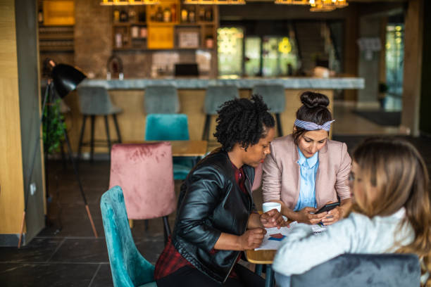 istock Three multi-ethnic female friends in cafe 1147579112