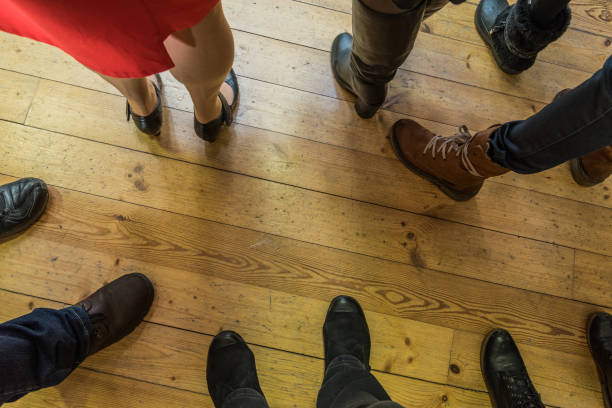 istock Legs on wooden floor. 1147579289