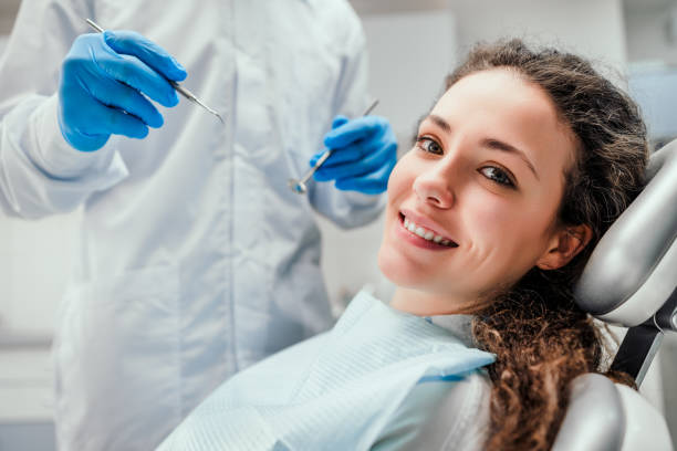 Healthcare and medicine concept. Smiling young woman receiving dental checkup. close up view. Healthcare and medicine concept. tooth whitening photos stock pictures, royalty-free photos & images