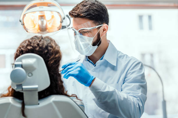 Healthcare and medicine concept. Dentist working in dental clinic with patient in the chair. dentists office photos stock pictures, royalty-free photos & images
