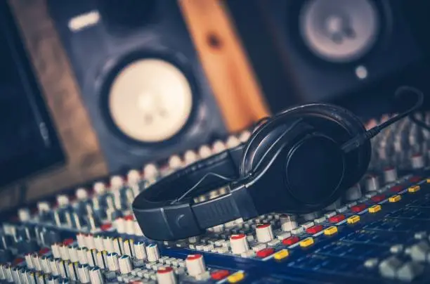 Sound Mastering Job. Audio Equipment in the Recording Studio. Professional Headphones and Audio Mixer. Modern Technology.