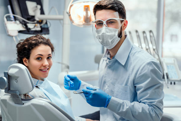 Healthcare and medicine concept. Beautiful woman patient having dental treatment at dentist's office. Woman visiting her dentist. dental hygienist stock pictures, royalty-free photos & images