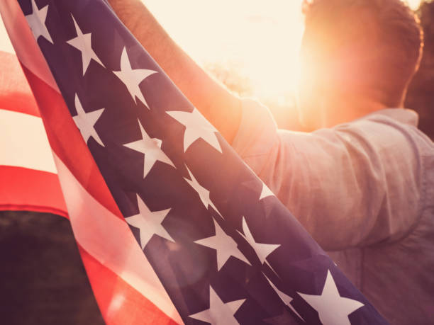 istock Handsome, young man waving an American flag 1147580028