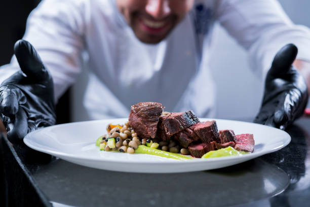 istock A professional chef prepares and decorates a dish with a delicious beef tenderloin 1147583625