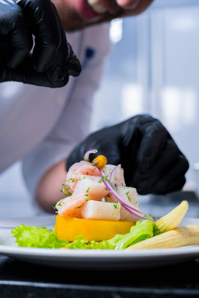 istock professional chef arranges on white plate delicious sea food 1147583695