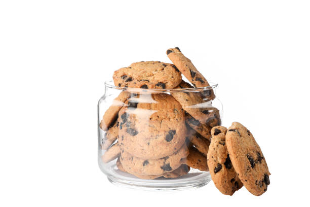 istock Glass jar with tasty chocolate chip cookies on white background 1147585589