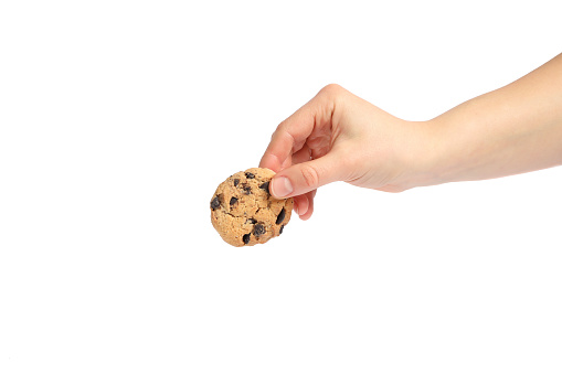 Woman holding tasty chocolate chip cookie on white background, closeup