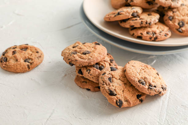 istock Plate with tasty chocolate chip cookies  on gray background. Space for text 1147586536