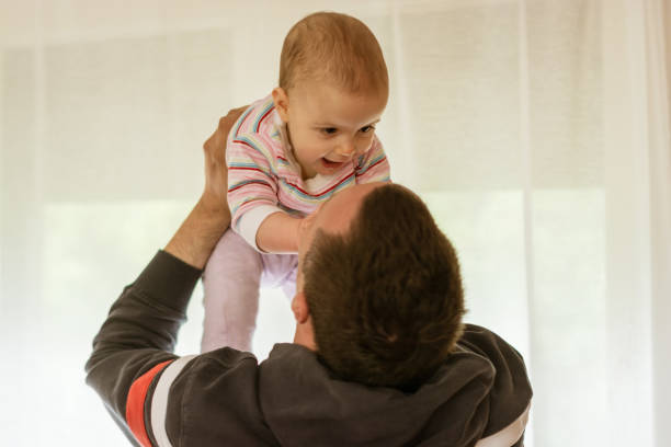 istock Happy father looking at baby 1147589321