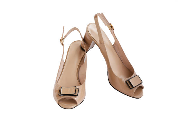 istock Beige feminine shoes with open toe and bow, isolated 1147589335