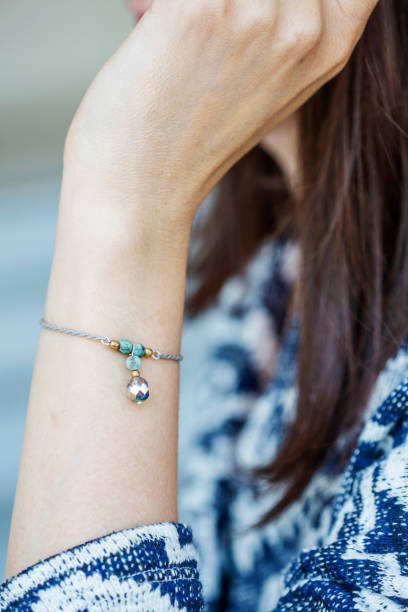istock Female wrist wearing tiny jewelry bracelet 1147594221