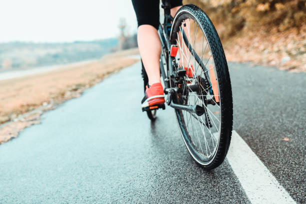 istock Female Riding A Bicycle On Asphalt Track 1147595852