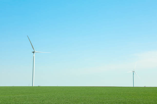 istock Wind turbines in a green grass field, space for text. Beautiful spring greenery 1147597517