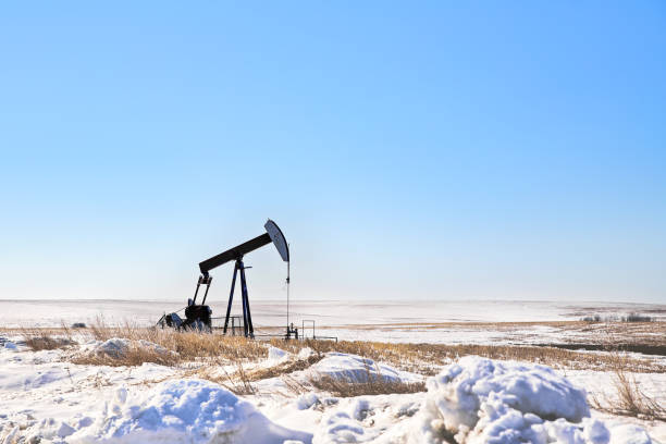 oil pump jack in winter landscape - oil pump oil industry alberta equipment imagens e fotografias de stock