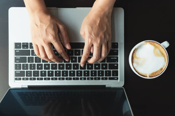 istock Hands typing a button on the laptop, top view 1147599856