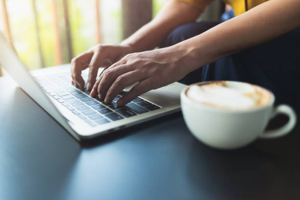 istock Woman was sitting typing a button on the laptop 1147599871