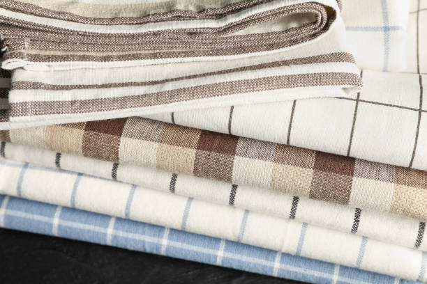 istock Stack of fabric napkins on black table, close up 1147602524