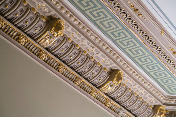 istock Stucco and luxurious decorative elements on ceiling. Luxury aesthetic in a home decor. Golden lion head pieces on a ceiling 1147606491