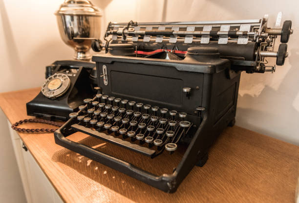 Close up colour image of the dusty keys of an old fashioned antique typewriter. Horizontal image with room for copy space.