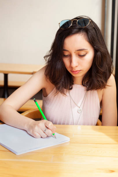 istock working young women writing something on paper 1147609093