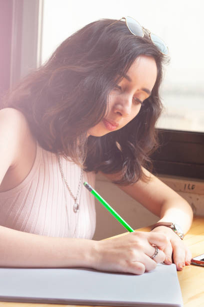 istock working young women writing something on paper 1147609096