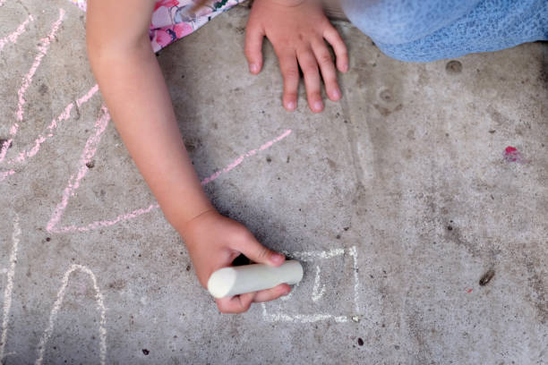 istock Girl draws with chalk 1147609365