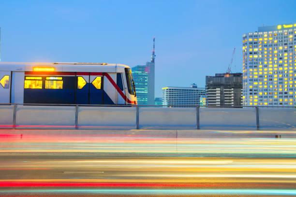 Sky Train on cityscape background Sky Train on cityscape background and light trails of traffic moving on the road an evening time, Sky Train is a mass transit system in Bangkok to help facilitate and speed the journey. bts skytrain stock pictures, royalty-free photos & images