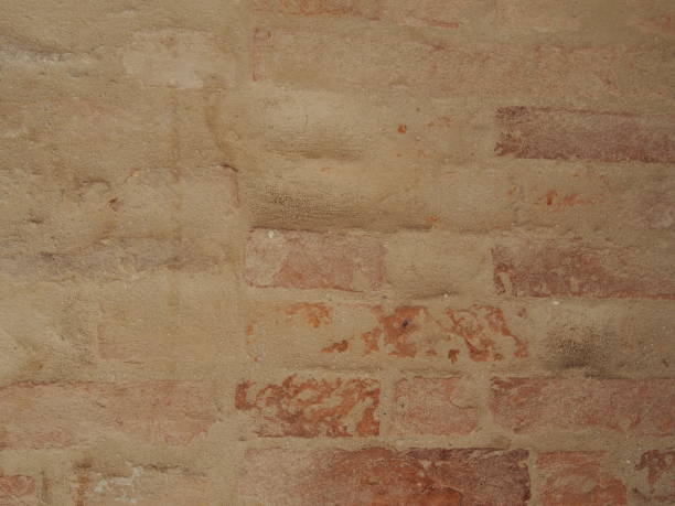 istock faded brick wall with worn away cement covering 1147610443