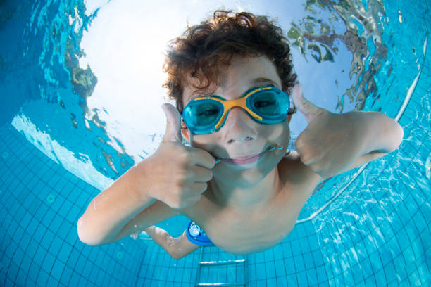 istock Underwater Young Boy Fun in the Swimming Pool with Goggles 1147610833