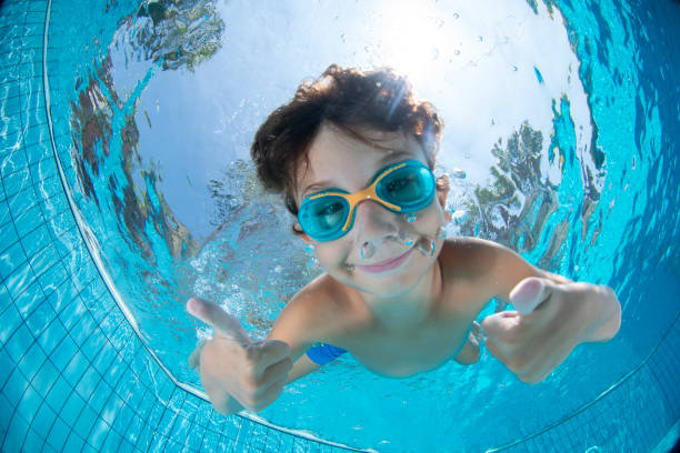 istock Underwater Young Boy Fun in the Swimming Pool with Goggles 1147610840