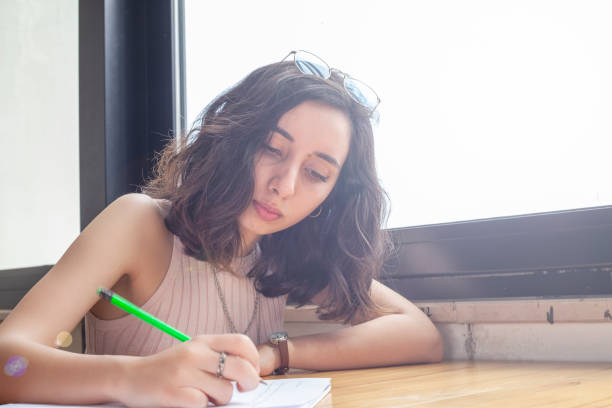 istock working young women writing something on paper 1147610998