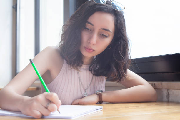 istock working young women writing something on paper 1147610999