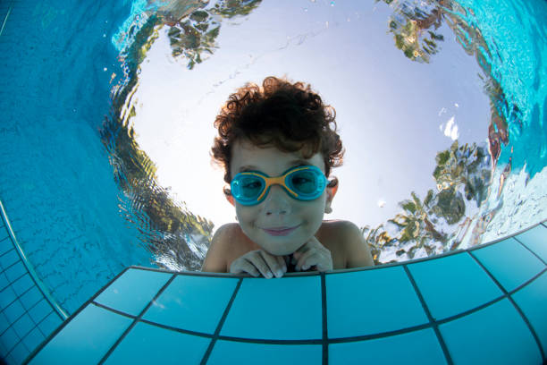 istock Underwater Young Boy Fun in the Swimming Pool with Goggles 1147611026