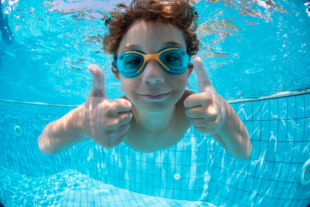 istock Underwater Young Boy Fun in the Swimming Pool with Goggles 1147611567