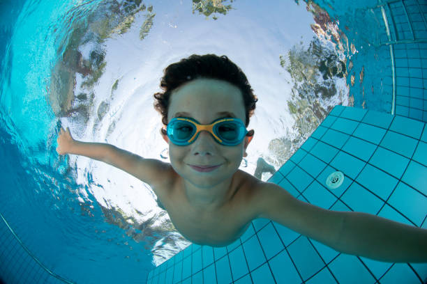 istock Underwater Young Boy Fun in the Swimming Pool with Goggles 1147611583