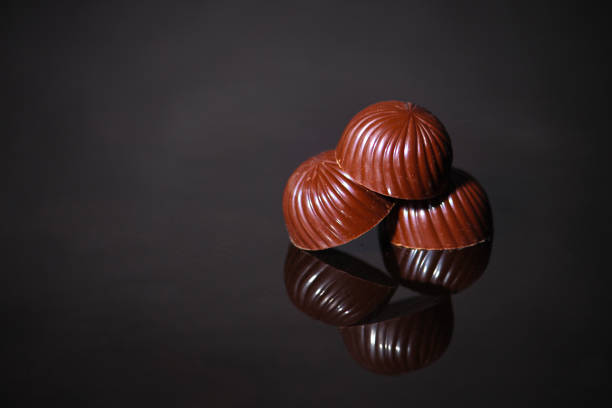 istock chocolate candy on a dark background. food background. top view 1147612067