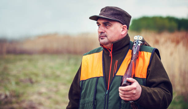 istock Hunter with a rifle in hunting 1147612077