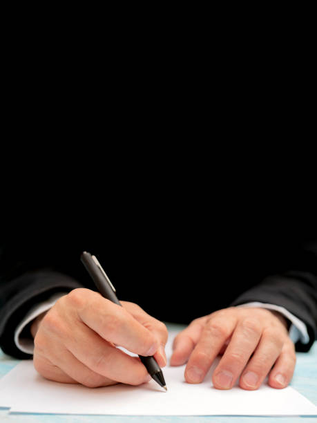 istock A pen in a man's hand. White sheet of paper. 1147613377