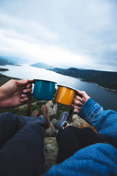 istock Two climbers in nature drinking coffee in enamel mugs 1147613459