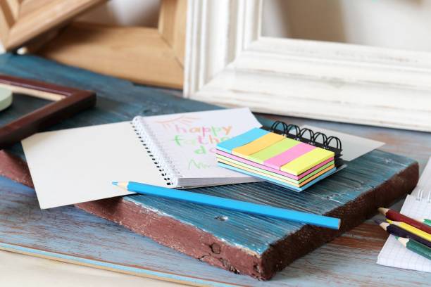 istock Tools, frame, notebook, congratulation on a wooden table, top view, father's day 1147615071