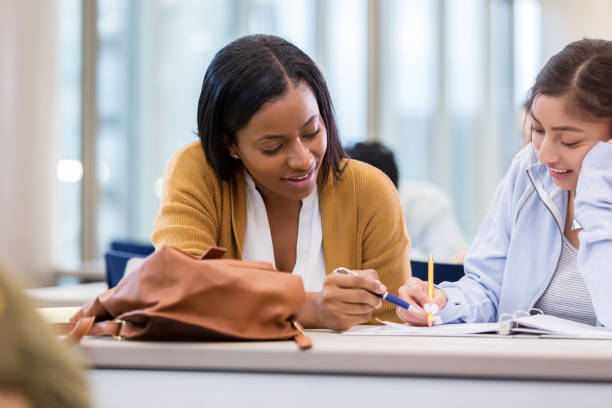 istock African American teacher helps Hispanic American student 1147615976