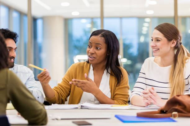istock Mid adult tutor gestures to student off camera 1147615981