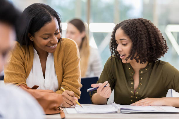 istock African American teacher helps mixed race student 1147616005